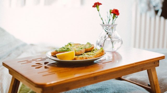 tray with avocado toast and flowers