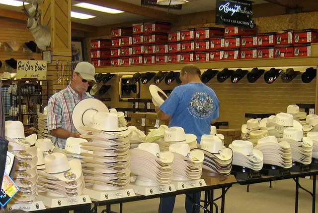 2 men shopping for cowboy hats