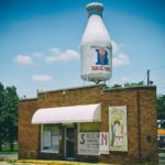 small building with braums milk bottle on top