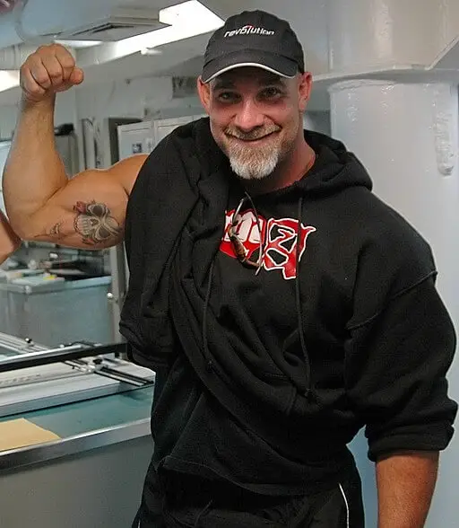 Bill Goldberg flexing his right arm bicep