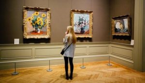 woman looking at art on the wall at a museum