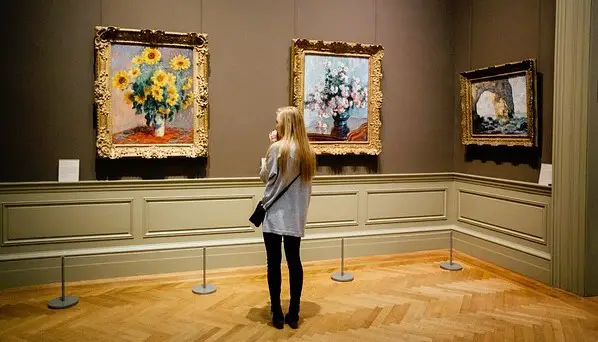 woman looking at art on the wall at a museum