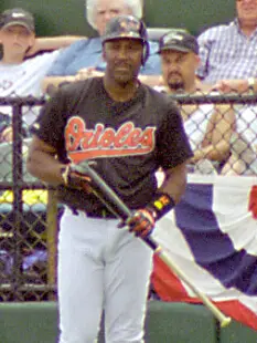 Joe Carter in his Orioles uniform holding a bat