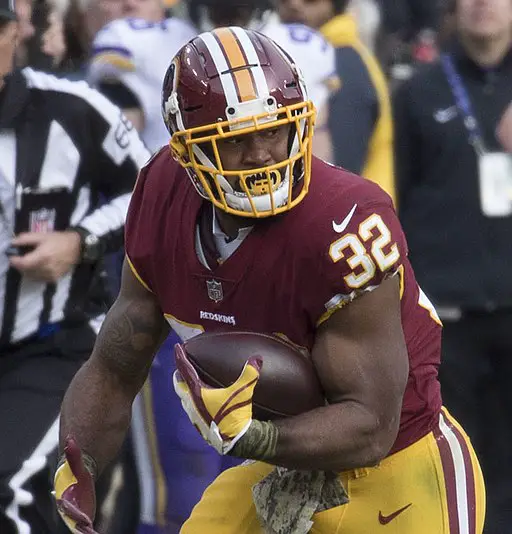 Samaje Perine running with a football during a game