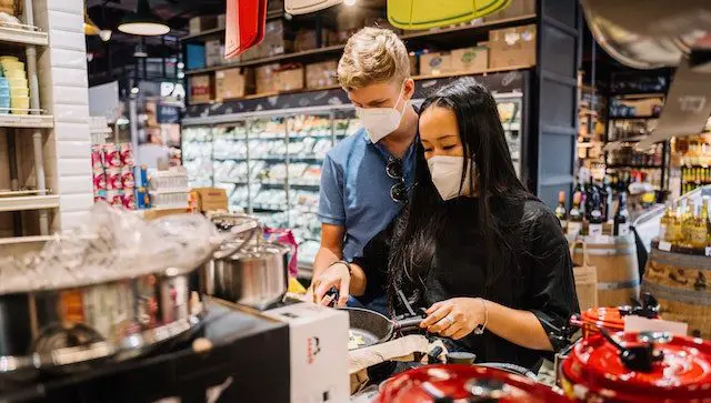 man and woman shopping in grocery store