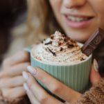 woman holding cup of hot chocolate