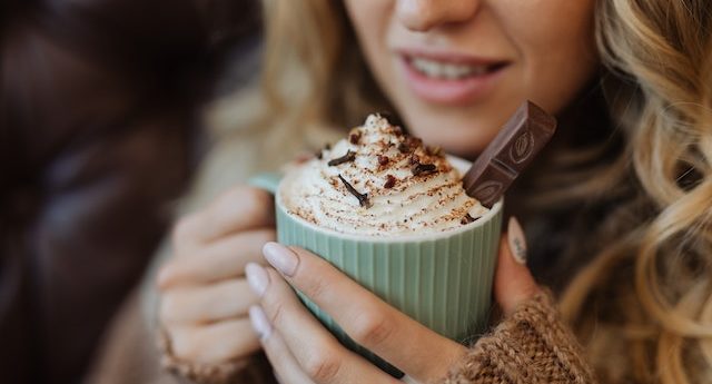 woman holding cup of hot chocolate