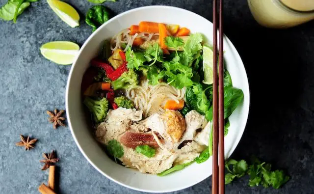 bowl of pho with chicken and vegetables