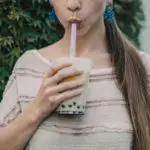 woman sipping on boba tea