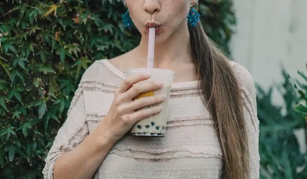 woman sipping on boba tea