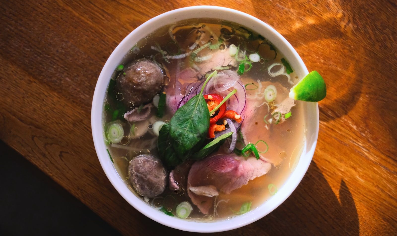 bowl of soup on wooden surface