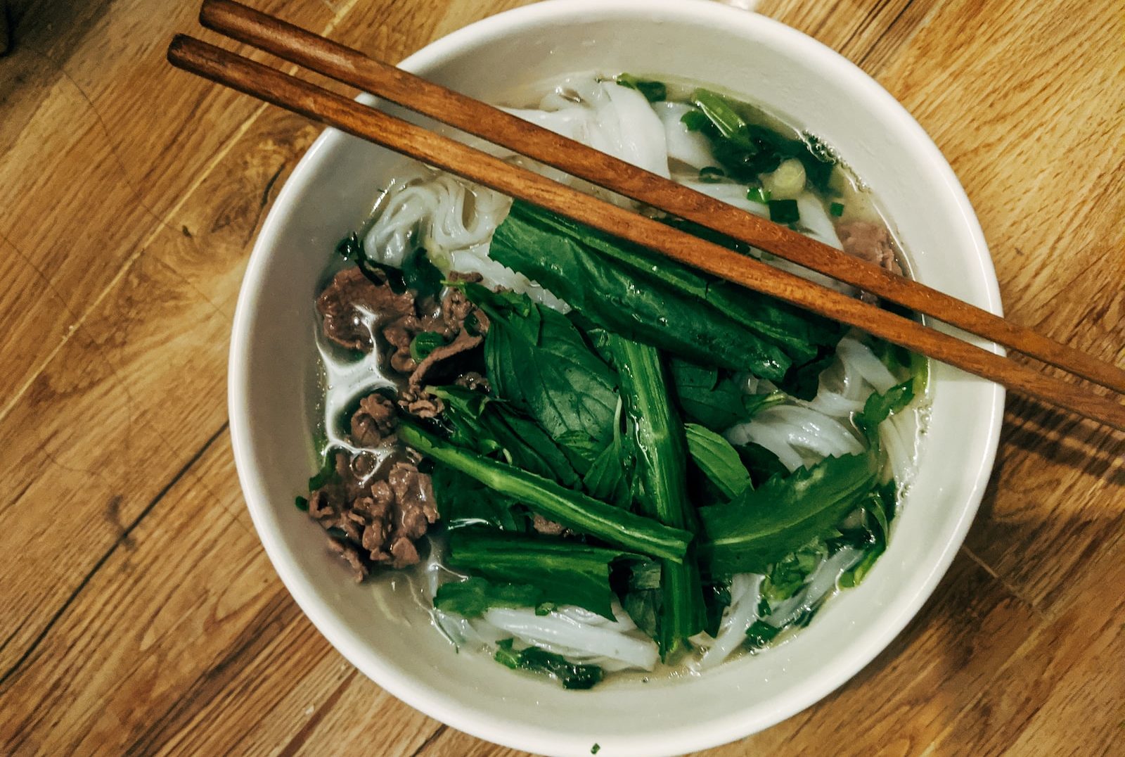 brown wooden chopsticks on white ceramic bowl