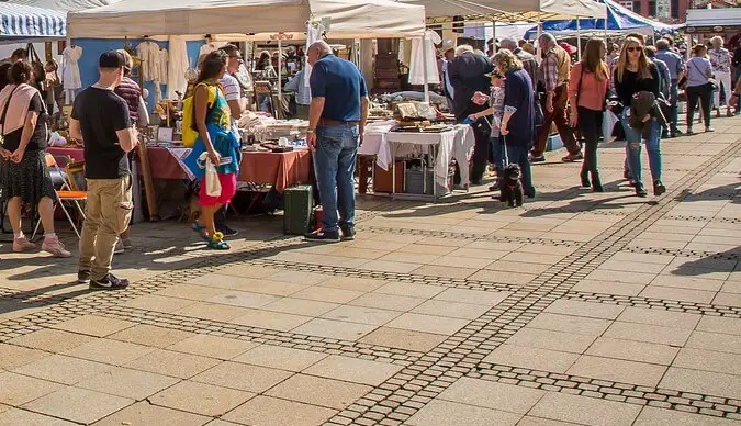 people outside shopping at a flea market with tents