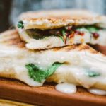 grilled cheese sandwich stacked on one another on top of serving platter