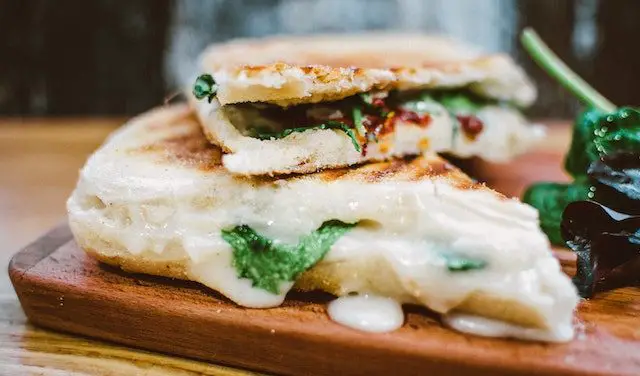 grilled cheese sandwich stacked on one another on top of serving platter