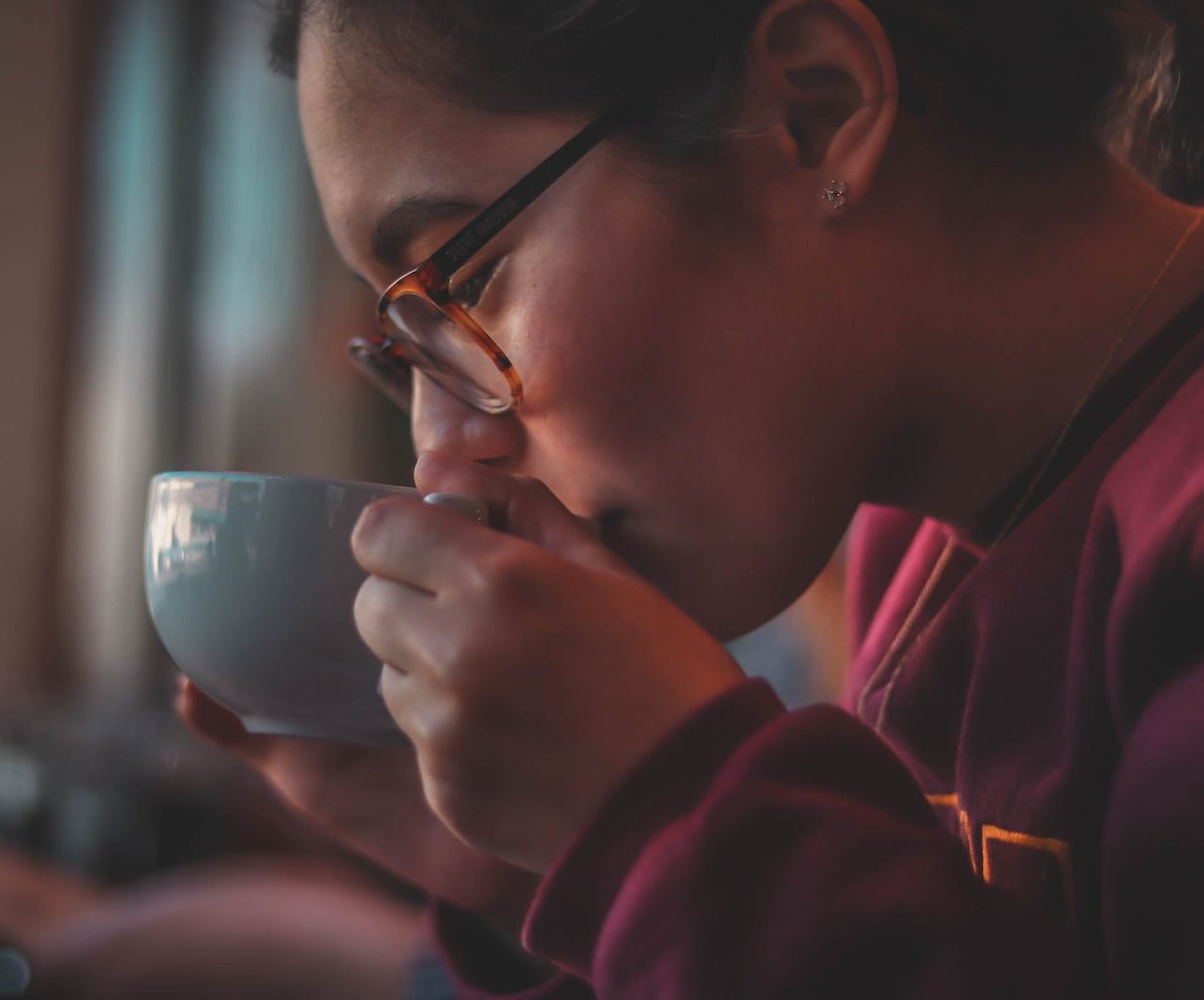 woman holding ceramic mug