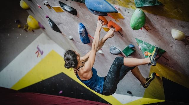 woman indoor rock climbing