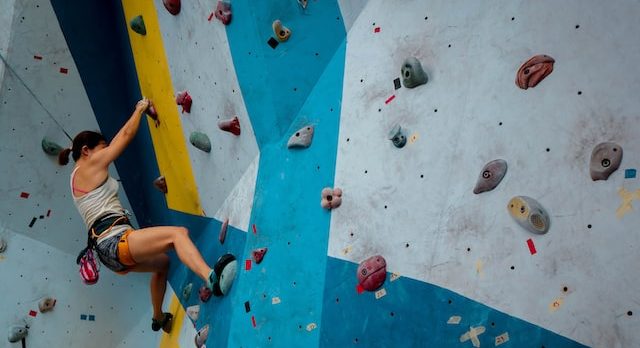 woman indoor rock climbing