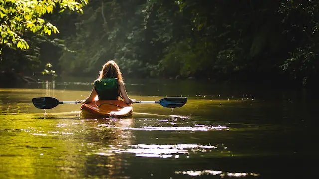 woman kayaking in river