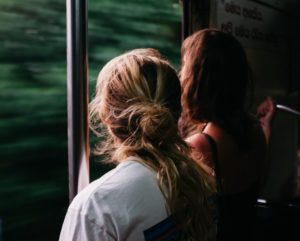 two person standing on train window