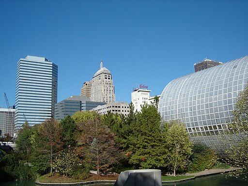 myriad botanical gardens in oklahoma city with trees and greenhouse, oklahoma city skyline in the background