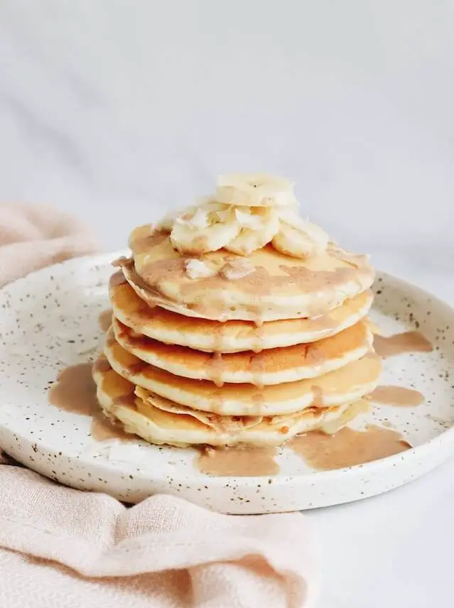 stack of pancakes with bananas on top