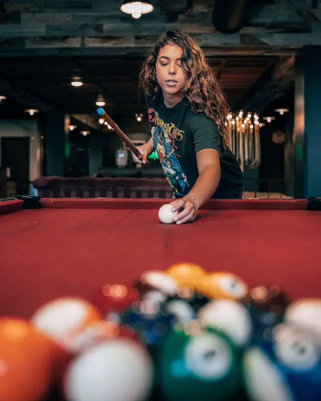 woman getting ready to break the balls during a game of pool