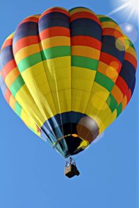 looking up at a hot air balloon in the sky