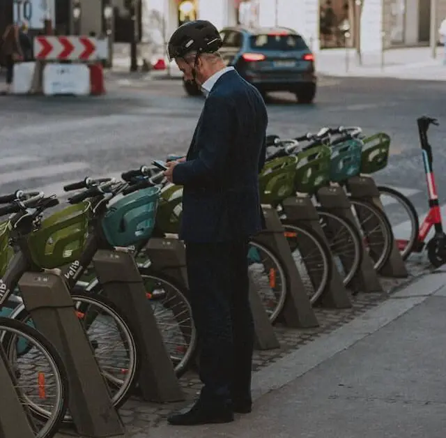 man in helmet renting from a rent-a-bike vending area