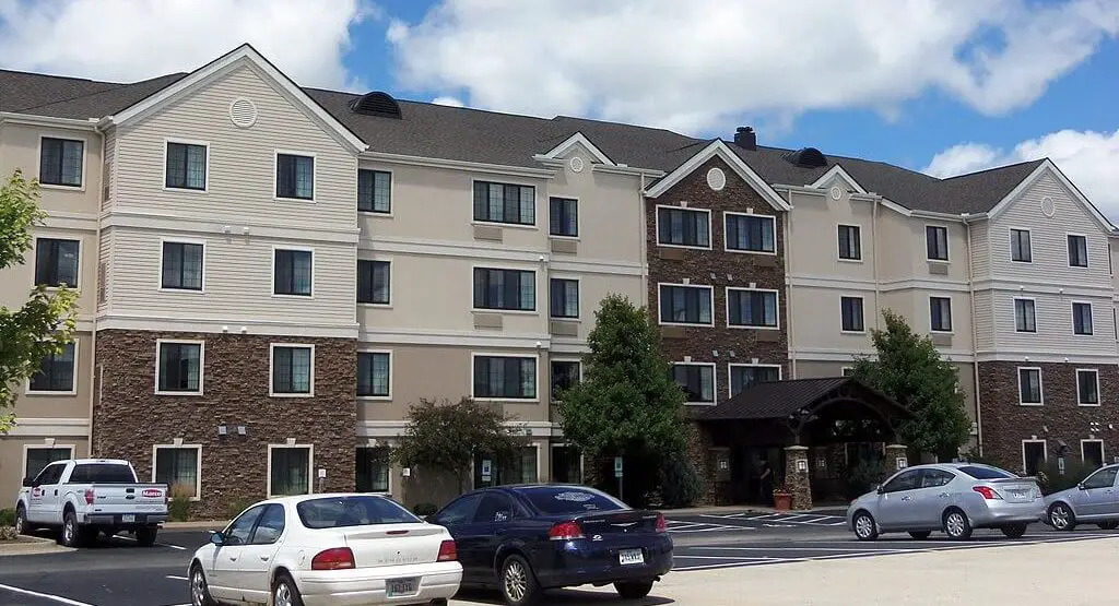 outside building of staybridge suites with cars in parking lot