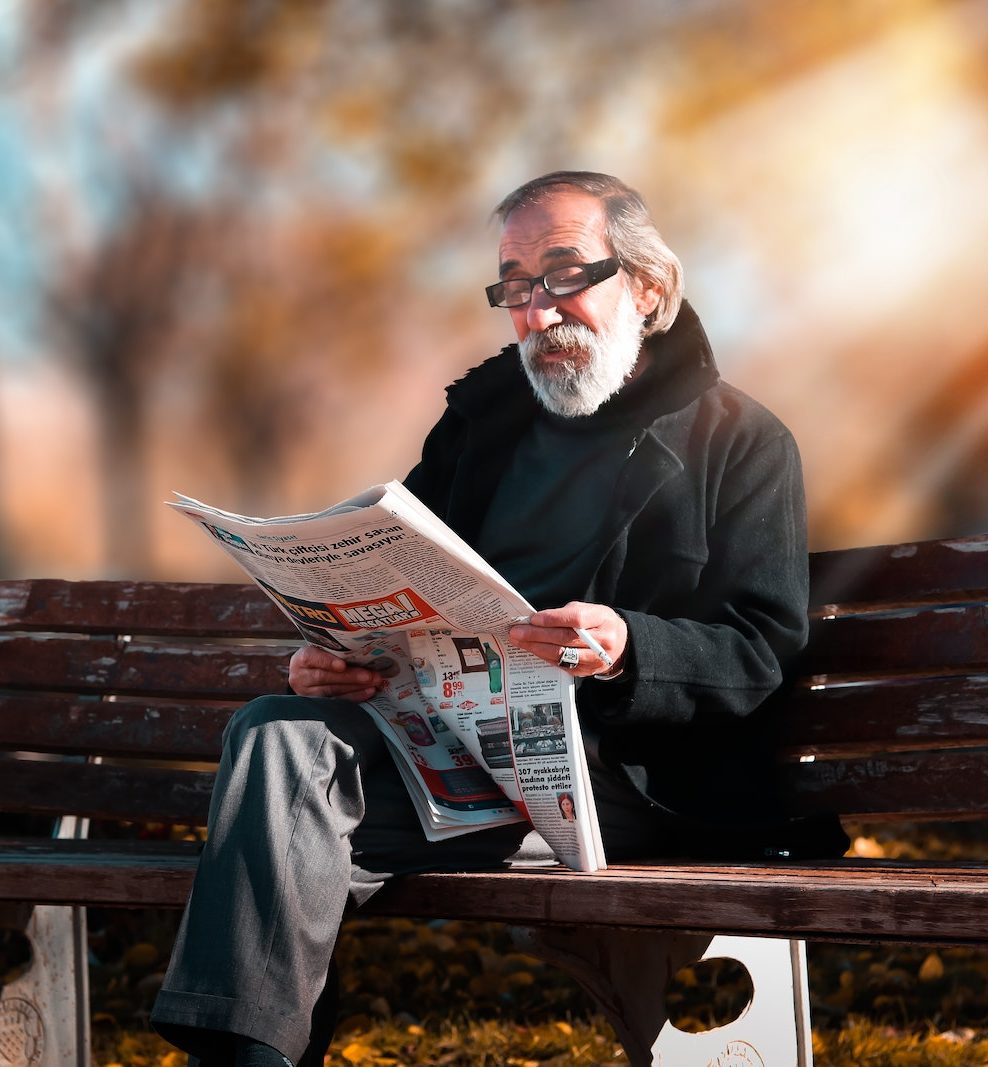 Photo of Man Reading Newspaper