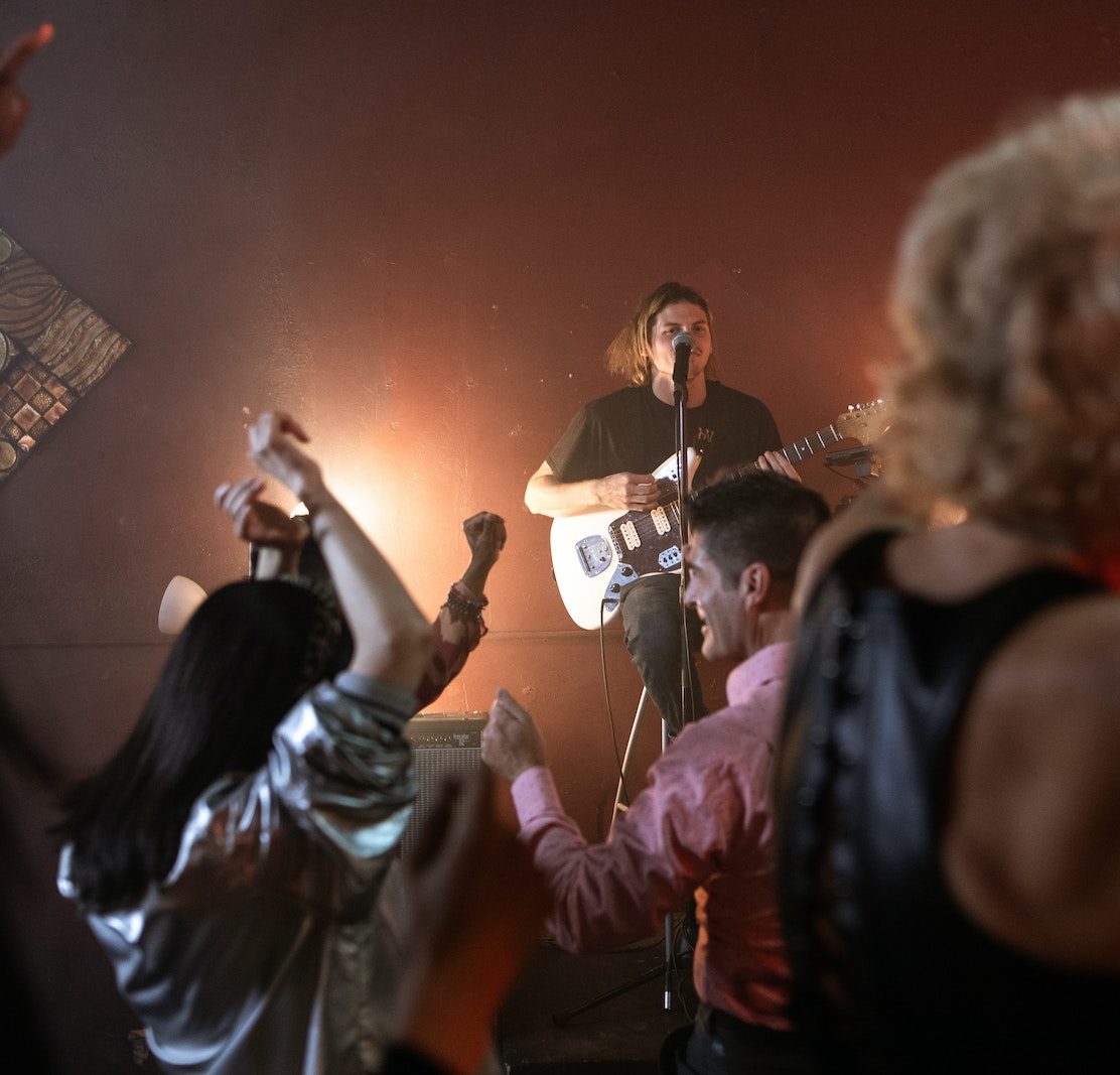 Person on the Stage Playing Electric Guitar