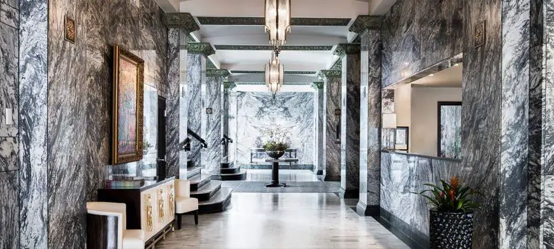 inside lobby of hotel with marble floor and walls