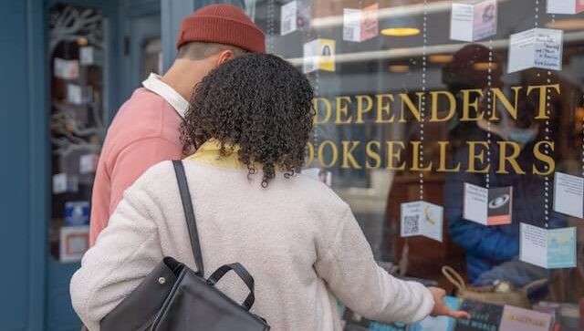 man and woman in front of a bookstore