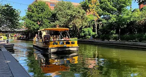 yellow water taxi on a small river in town