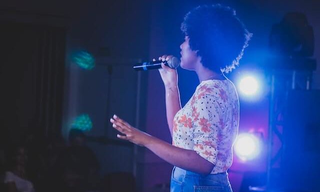 woman singing on a stage