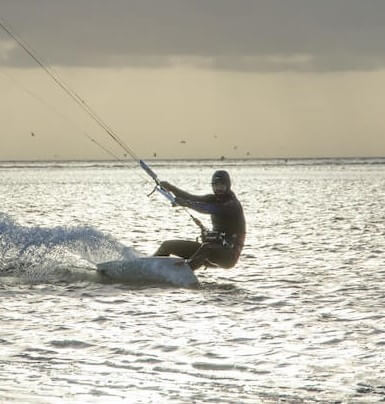 man kite surfing on the water