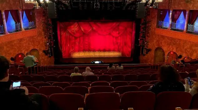 theater room with seats and curtains on stage