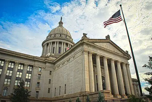 front of oklahoma state capitol building with American flag