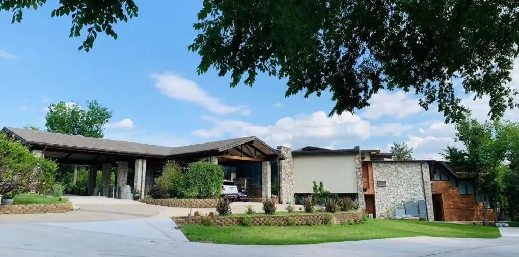 front of large rock home