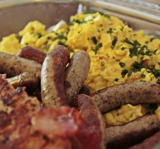 sausage, scrambled eggs, bacon on a plate