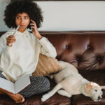 woman on couch with dog thinking about what she is going to write