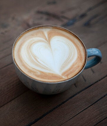 a latte with art in the shape of a heart