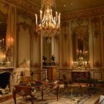 Victorian era sitting room with fireplace, chandelier, and Victorian furniture