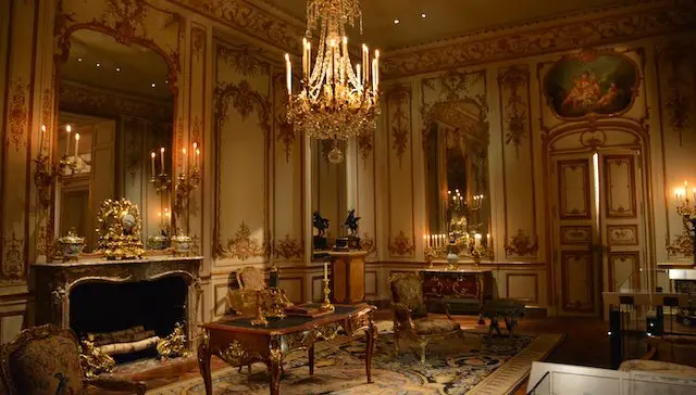 Victorian era sitting room with fireplace, chandelier, and Victorian furniture