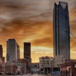 downtown oklahoma city with an evening sky of orange clouds