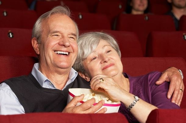 a senior couple watching a movie 