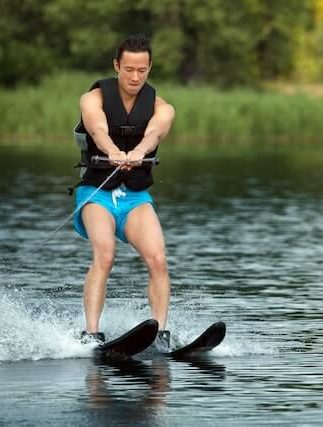 man water skiing on a lake