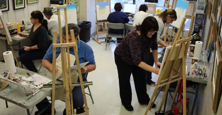 A room full of adults painting art