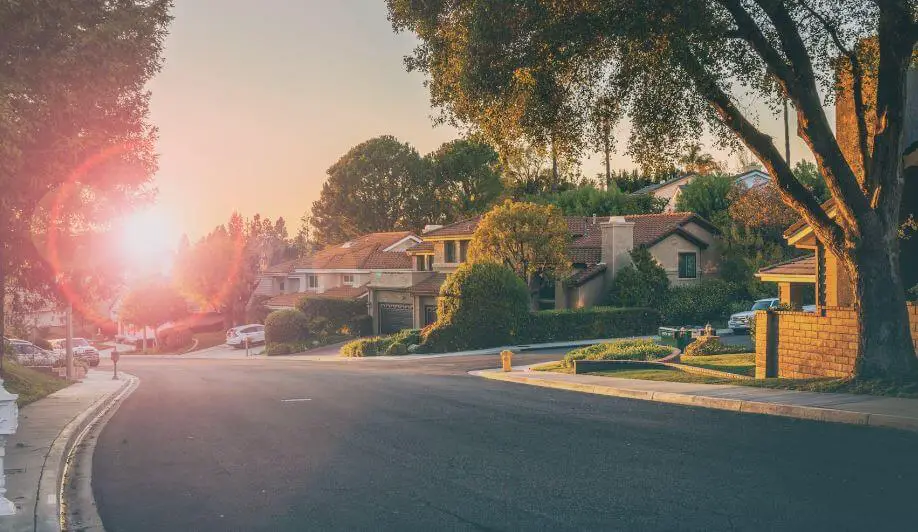 photo of a street in a neighborhood during sunset